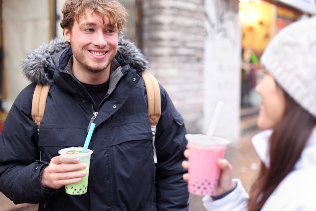 Friends in city drinking bubble tea.